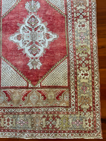 Dimensions: 3'6" x 5'5"  palette includes pops of pink, olive, sky blue, cherry, ecru and bronze.  Vintage Turkish Anatolian rug c. 1970, hand knotted of wool.&nbsp;